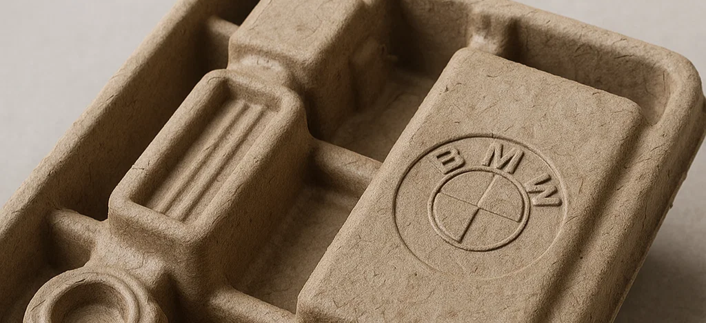 Recycled paper moulded pulp tray designed for automotive components, showcasing thermoformed packaging with precise contours and sustainable materials.